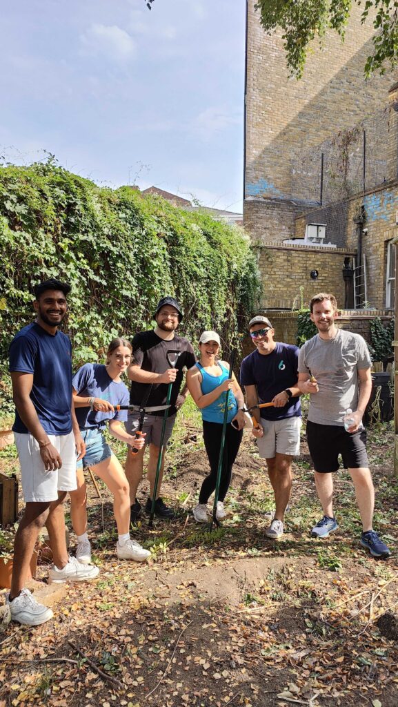 6sense employees volunteer to clean up a garden