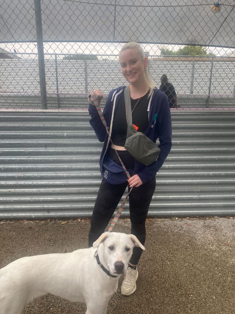 A female 6sense employee walks a dog