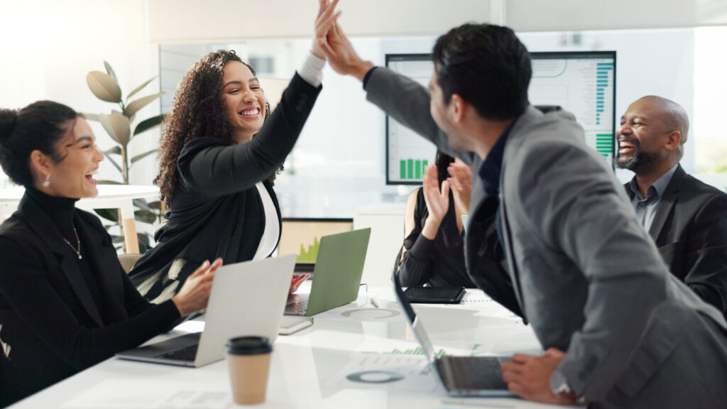 Sales and marketing celebrating a win with a high five