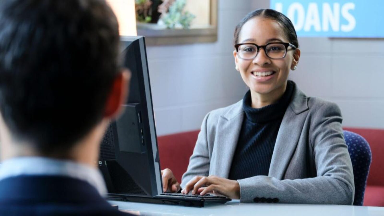 A demand gen marketer discusses marketing strategies with a bank colleague.