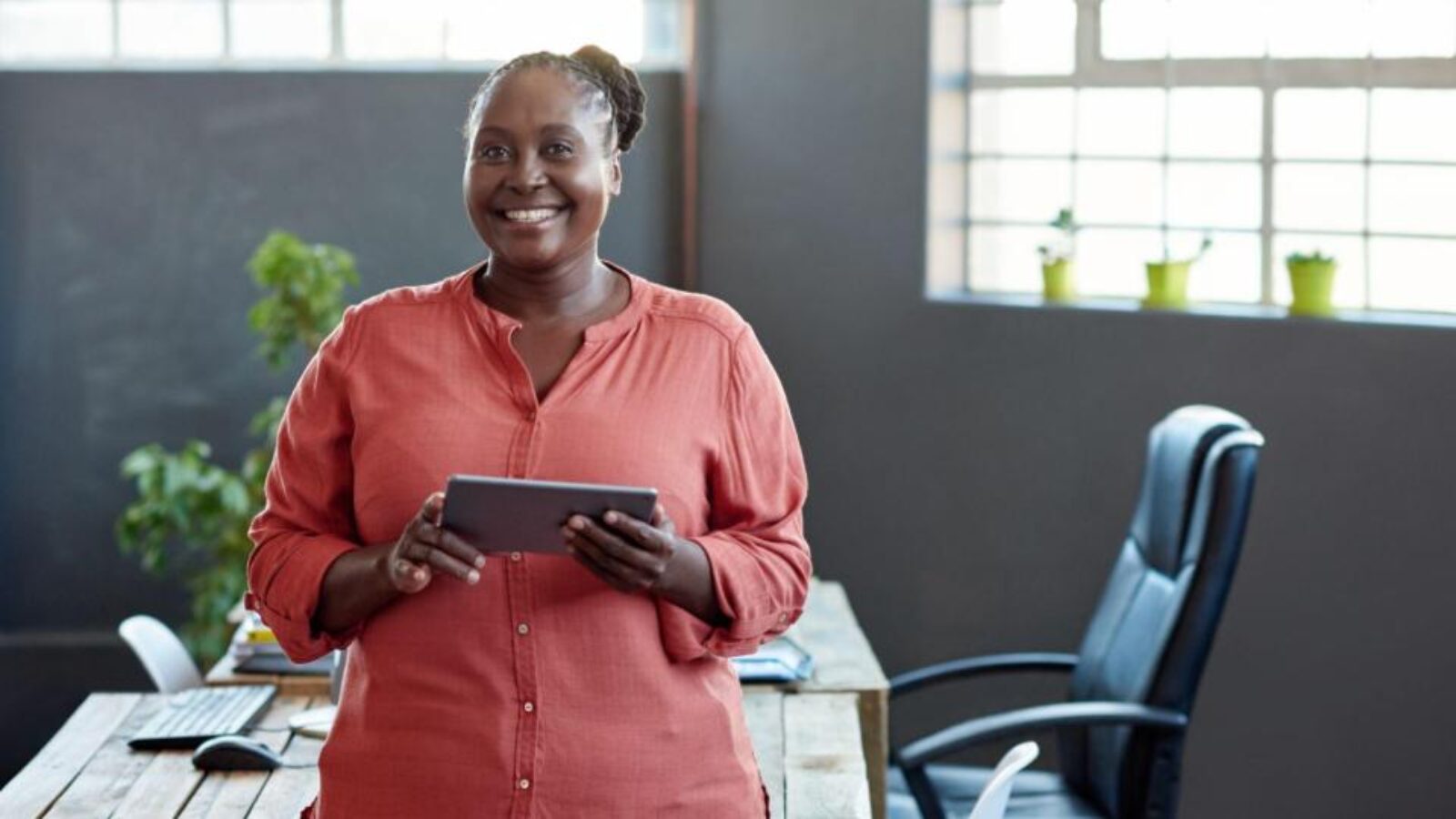 A happy ABM marketer holds her tablet.