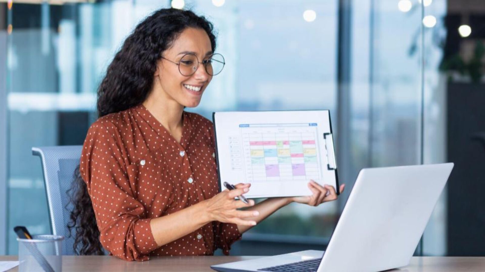 A marketer shows the marketing calendar to a team member.