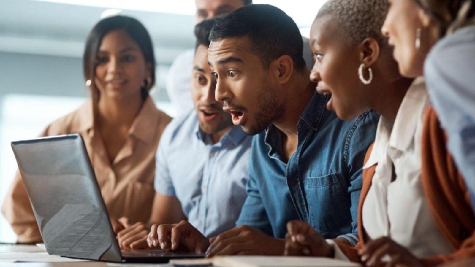 BDRs gather around a computer