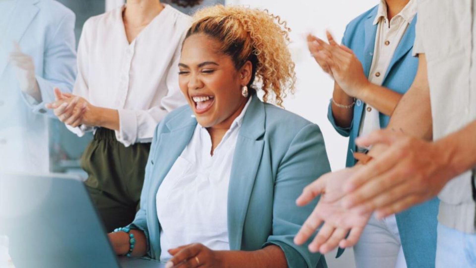 Excited sales team celebrates a big deal.